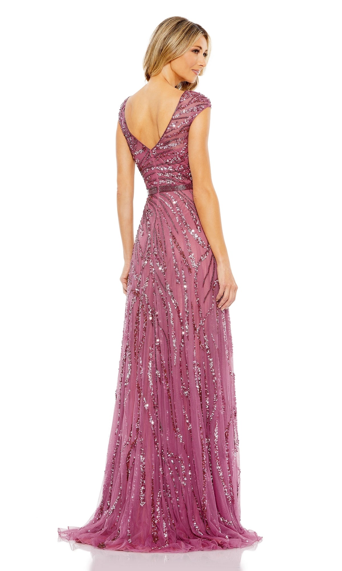 A woman stands facing away from the camera in a floor-length, mauve Mac Duggal 5445 High-Neck Beaded Formal Gown, featuring cap sleeves, intricate sequin embellishments, and a V-shaped back.